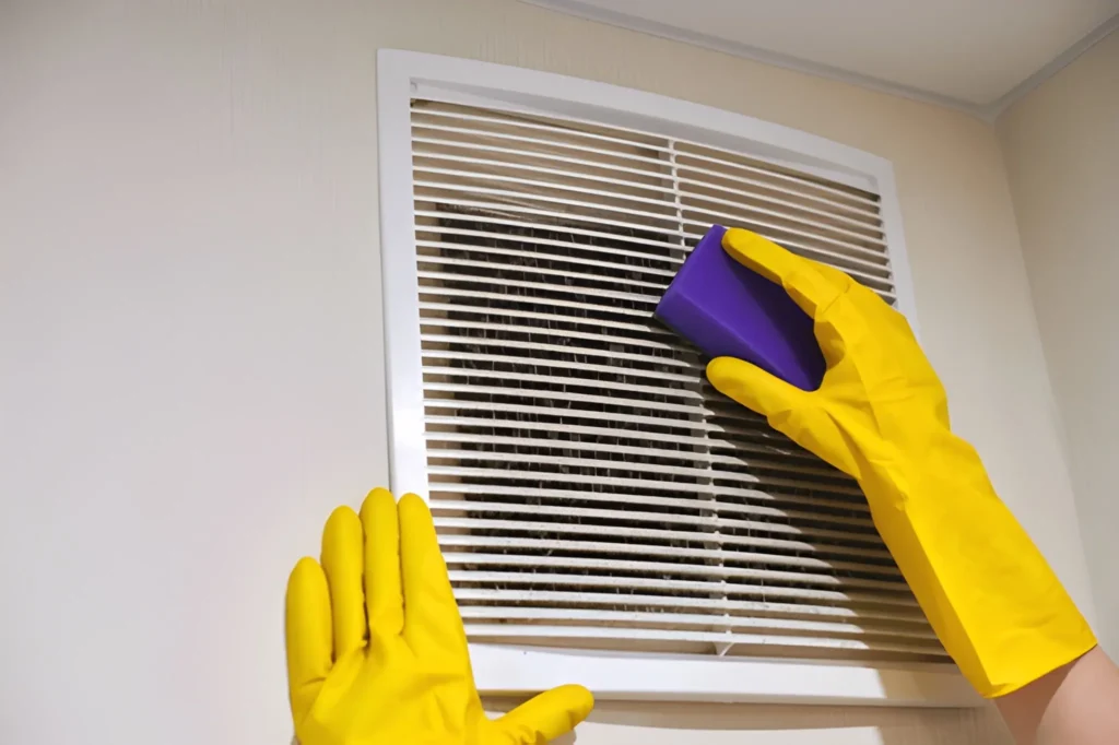 Close-up of professional AC Vent Cleaning equipment removing dust and debris from home vents.