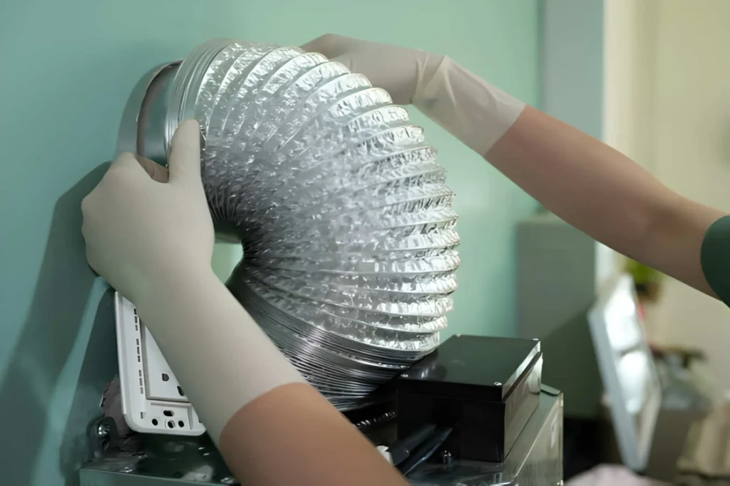 Technician performing professional Dryer Vent Installation to improve airflow and home safety.